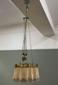 An Edwardian brass light with cream fabric shade and tassel, with rise-fall movement (d. 46cm)