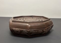 A late 20thc Chinese octagonal stoneware incense burner with cover and pierced top, with moulded