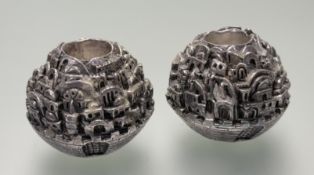 A pair of Depiction of Jerusalem silver cast table candleholders designed by Sam Philipe, signed