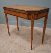 An Edwardian inlaid satinwood fold-over card table, hexagonal cross-banded top opening to reveal