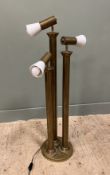 A Mid-Century Bauhaus style three-armed brass floor lamp with milk glass trumpet shades on