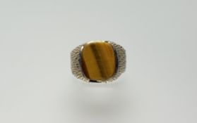 A 9ct gold signet style ring with hatched mount set tigers eye O/P 362g