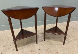 A pair of reproduction mahogany drop-leaf occasional tables, by the Bombay Company, triangular top