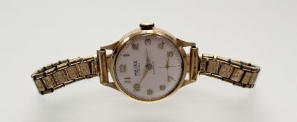 A vintage Majex 9ct gold manual wind wristwatch with silvered dial and arabic numerals and seconds