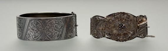 An Edwardian Chester silver engraved stiff hinged bangle with a safety chain: d. x 6cm 32.5g, a