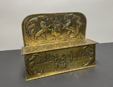 A Dutch 19thc brass embossed candle box, decorated with coat of arms to top and figures in a