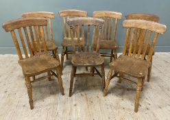 A set of seven early 20th century oak farmhouse-style dining chairs, curved tops over spindle