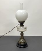 An early 20thC oil lamp with milk glass and clear glass shades, complete with a Messengers burner,