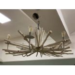 A contemporary wooden chandelier, in the form of splayed tree branches, with six arms for lightbulbs