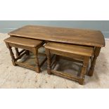 A modern elm set of three nesting tables, by Ercol. Larger table with rectangular top and rounded