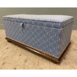 An Edwardian oak-framed Ottoman, blue geometric upholstery with pineapple motifs, lifting to
