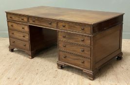 An impressive 19th-century mahogany partner's desk, rectangular cross-banded top with faux drawers
