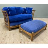 A modern two-seater elm sofa, model "Renaissance" by Ercol, with cushions to back and seat, and