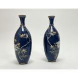 A pair of Japanese Meiji period cloisonne enamel vases, each decorated with birds amongst a