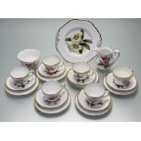 A Spode part tea service with various hand-painted flowers to centre with gilt rim comprising, a