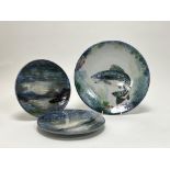 A large Highland Stoneware footed plate decorated with a fish to centre on a mottled green and