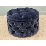 A contemporary upholstered footstool, circular buttoned top and sides upholstered in deep blue