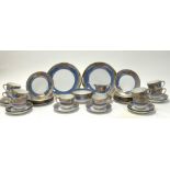 A Noritake blue lustreware tea service decorated with gilt scrollwork and foliate detail