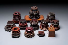 A collection of 38 Chinese wooden stands and a box, 19/20th C.
