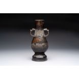 A fine Chinese archaistic bronze 'Hu' vase with dragon handles, Yuan