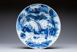 A large manganese, blue and white Dutch Delft chinoiserie dish, 17th C.