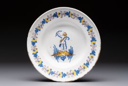 A rare polychrome Dutch Delftware 'Compendario' dish with an arching putto, probably Verstraeten wor