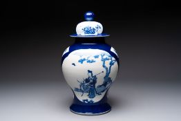 A Chinese blue and white powder-blue-ground 'He Xiangu' vase and cover, 19th C.