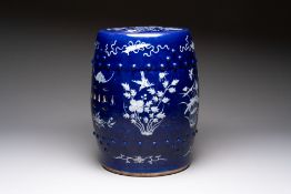 A Chinese white-slip-decorated blue-ground garden seat with floral design, 19th C.