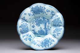 A blue and white Dutch Delft dish with a Chinese 'Gu' vase and a flower basket, 17th C.
