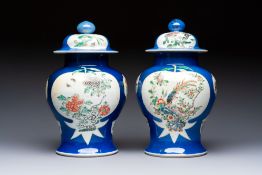 Two Chinese famille verte blue-ground vases and covers, 19th C.