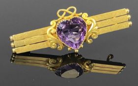 15CT GOLD TRIPLE-BAR BROOCH, c. 1900, set with heart shaped amethyst, 45 x 15mms, 5gms Provenance: