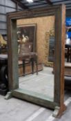 INDIAN CARVED TEAK ARCHITECTURAL STANDING MIRROR, carved foliate frame on sleigh feet, foliate