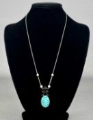 CHINESE JADE PENDANT with 9ct white gold mount, set with seed pearls, integral fine link chain