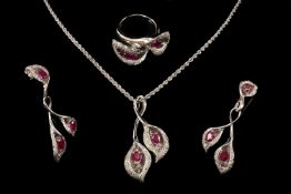 18CT WHITE GOLD RUBY & DIAMOND FLORAL JEWELLERY SUITE, comprising pendant on chain, ring and pair of