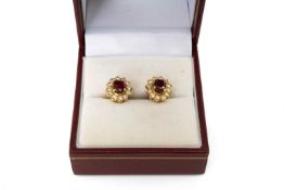 PAIR OF 14K GOLD RUBY & DIAMOND EARRINGS, oval cluster, each with 12 small diamonds surrounding