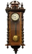 VIENNA WALNUT CASED CHIMING WALL CLOCK, with pendulum and two weights, 117 (h) x 47cms (w)