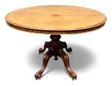 VICTORIAN MAHOGANY LOO TABLE, oval tilt top, four scrolled supports with pottery castors, 70 (h) x