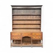 GEORGE III OAK WELSH DRESSER, tall boarded plate rack back having four shelves, open base having