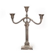 Three-armed silver candlestick with ionic capitals