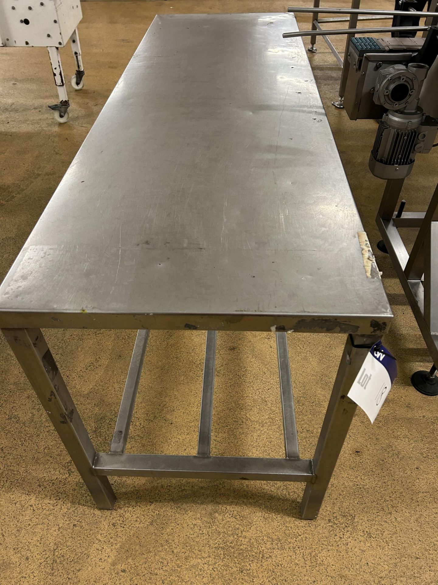 Table, with railed shelf below, approx. 1.8m x 0.6m x 0.8m high, lift out and loading charge +