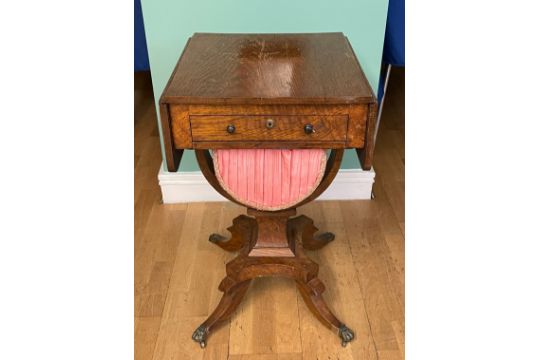 A Victorian oak sewing table, having drop-leaf top, with single frieze drawer and slide out - Image 1 of 2