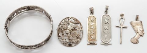 An 800 Egyptian silver hinged bangle, an Egyptian silver brooch, two 800 silver pendants, a silver