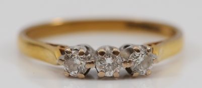 An 18ct gold brilliant cut diamond three stone ring, J, 1.8g