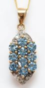 A 9ct gold diamond and gemstone pendant, either tanzanite or blue topaz, on a chain, 3.3g