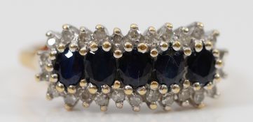 A 9ct gold sapphire and diamond cluster ring, stated 0.15ct, M, 2.6g
