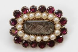 A George IV garnet and seed pearl mourning brooch, with hair work and engraving to the rear, 22mm,
