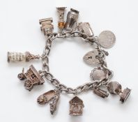 A silver charm bracelet with eleven silver charms, UK hallmarks, London date letter part worn, 61.