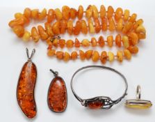 Two 925 silver mounted amber pendants, a 925 silver and amber ring, P, a 925 silver and amber