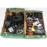 A collection of cameras to include a Minolta Dynax 3000i, a Praktica MTL5B, Praktica LLC and others.