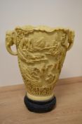 A large reproduction simulated ivory vase, of Chinese design and moulded in relief, with elephant